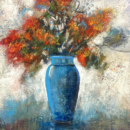 Bring colour, warmth and expressive energy into your home with this beautiful original mixed floral artwork with grasses, featuring a striking arrangement of flowers displayed in a blue vase. This contemporary still life painting combines bold colour with soft, textured detail, creating a piece that feels both lively and elegant. The vivid floral tones contrast beautifully with the cool blue vase, while the loose, expressive brushwork gives the artwork a sense of movement and depth.